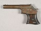 an old gun with a wooden handle on a white surface