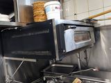 an image of a commercial kitchen with a stove and oven