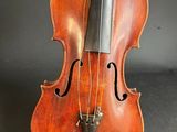 an old violin sitting on top of a black surface