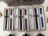 several watches are in a box on a table with other watches