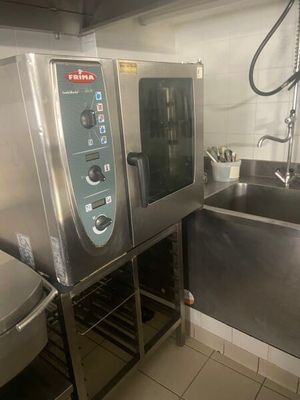 a commercial kitchen with two ovens and a sink