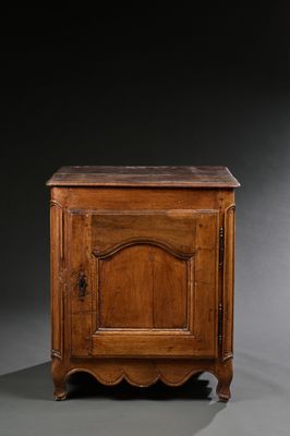 un petit meuble en bois muni d'une porte et d'un tiroir au-dessus