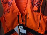 an orange safety vest with a tag on it hanging on a rack