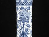 un vase bleu et blanc posé sur une surface noire