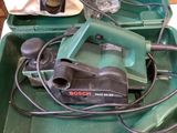 a green tool box with tools in it on a table