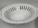 a white bowl sitting on top of a table next to a plate