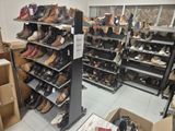 many pairs of shoes on the shelves in a shoe store