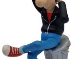 statue of a man sitting on top of a trash can with a hat on his head