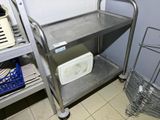 a metal cart that is sitting in the corner of a room