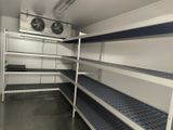 a room with a lot of shelves and a fan in it