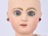 a close up of a doll with a bald head