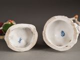 two porcelain figurines that are sitting on a table