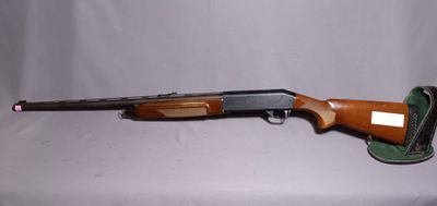 a shotgun that is sitting on top of a table