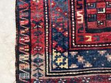 a close up of a red and blue oriental rug