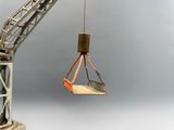 a crane that is holding a piece of metal