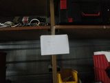 a sign on a pole in a garage with other items