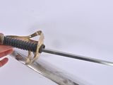 a person holding a sword in their hand on a white surface
