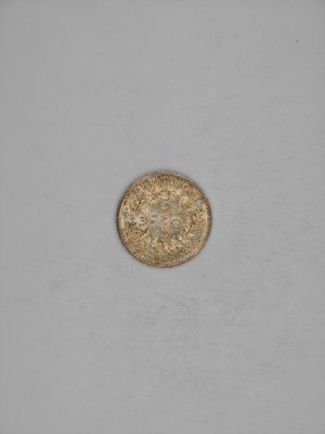 a gold coin with a small hole in the middle of it