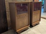 two wooden cabinets with glass doors on each of them