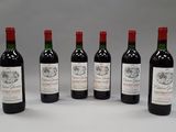 six bottles of red wine are lined up in a row