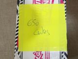 a box with a yellow sticker on it sitting on the floor