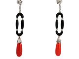 a pair of earrings with black and red beads