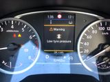 a close up of a car dashboard with various gauges