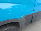a close up of a blue truck with a black stripe on the side
