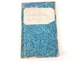 an old book with a piece of paper on top of it
