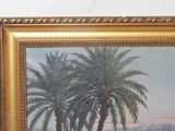 a painting of two palm trees in a gold frame