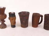 five different types of vases and cups on the table