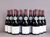 six bottles of wine are lined up on a table