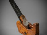an old wooden planer with a wooden handle on a gray background