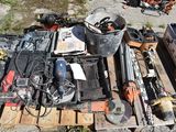 a pile of tools on a pallet on the side of the road