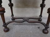 a small table with a marble top and wooden legs