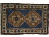a blue and brown rug with a star design on it