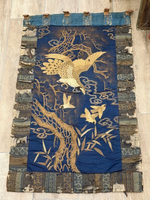 an image of a blue and gold rug with birds on it