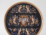 a blue and gold plate with a design on it