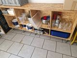 a shelf that has many containers and containers on it