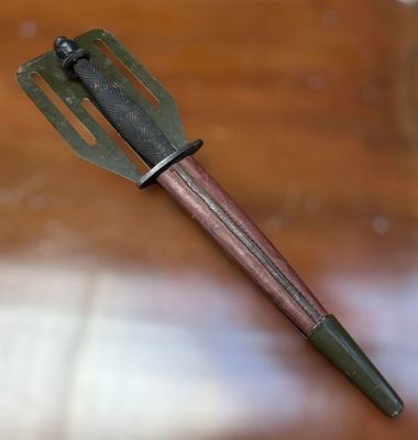 a metal fork with a wooden handle sitting on a table