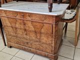 a wooden table with a marble top in the middle of a room