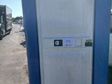 des toilettes portables bleues posées au bord de la route