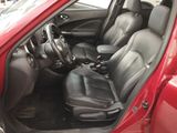 a red car with black leather seats and a steering wheel