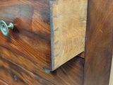 a close up of a wooden dresser with two drawers