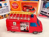 a toy fire truck with a ladder on top of it next to other toys