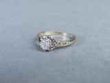 a close up of a diamond ring on a gray surface