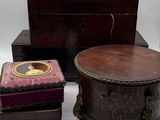 three wooden boxes and a pair of shoes on a white surface