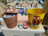 a yellow bucket and a brown bucket sitting on top of a cardboard box