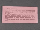 a pink piece of paper on a black surface