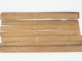six pieces of wood are arranged on a white surface